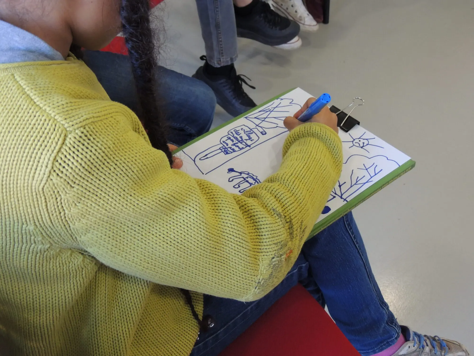 Une élève d'école primaire dessine ce qui est débattu sur le sujet de la différence et du vivre-ensemble.